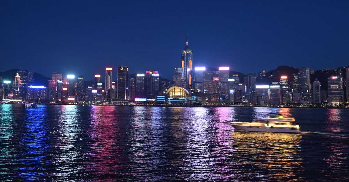 A stunning night view of Hong Kong's illuminated skyline reflecting on Victoria Harbour.